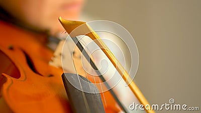Young woman playing the violin. Hands of musician, close up view. Front view Stock Photo