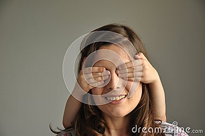 A young woman plays hide and seek with her son Stock Photo