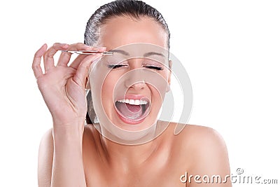 Young woman plucking her eyebrows with tweezers Stock Photo