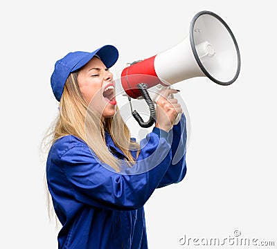 Young woman with plumber clothes isolated over grey background Stock Photo