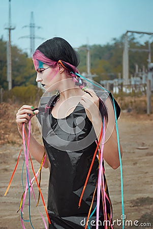 Young woman in polyethylene dress with ribbons Stock Photo