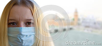 Young woman portrait with medical mask, blurred London city background. Concept covid-19 prevention coronavirus pandemic Stock Photo