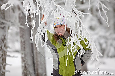 Young woman posing at camera in winter mountains Stock Photo