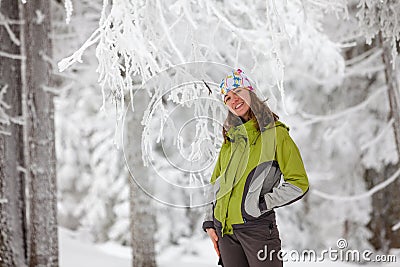 Young woman posing at camera in winter mountains Stock Photo