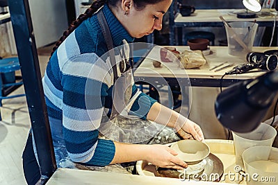 Young woman potter works with clay Stock Photo