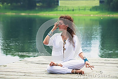 Young woman practice yoga breathing techniques outdoor Stock Photo