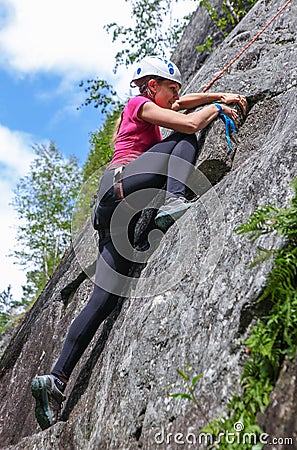 Young woman practicing climbing on natural rocks Editorial Stock Photo