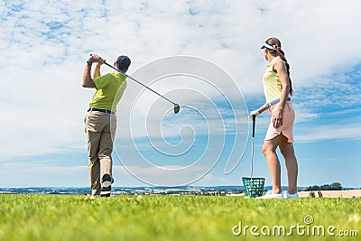 Young woman practicing the correct move during golf class Stock Photo