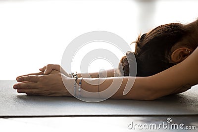 Young woman practicing yoga, doing meditation exercise Stock Photo