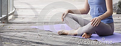 Young woman practicing yoga during yoga retreat in Asia, Bali, meditation, relaxation in abandoned temple Stock Photo