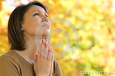 Young woman praying Stock Photo