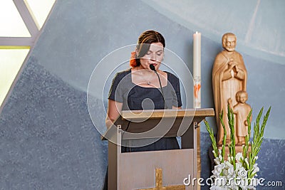 Young woman preaching in christian church Stock Photo