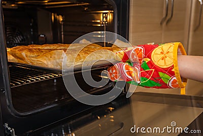 Woman pulled from the oven apple pie Stock Photo