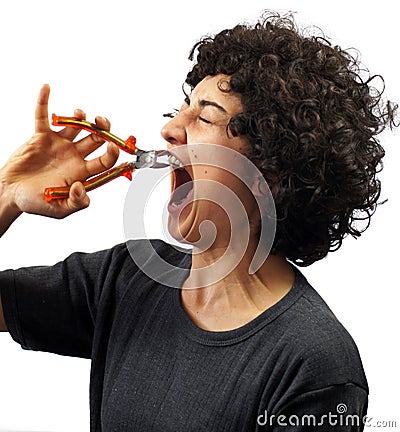 Young woman pulls her tooth out Stock Photo