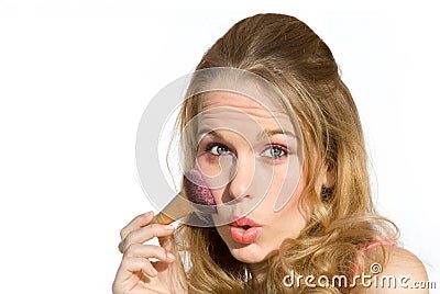 Young woman putting on makeup Stock Photo