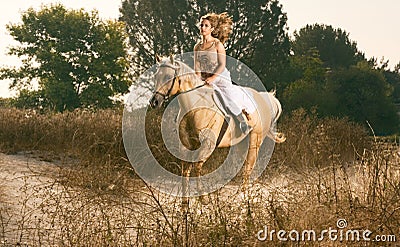 Young woman racing on horse (motion blur) Stock Photo