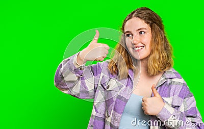 Young woman raises thumbs up agrees or gives positive reply recommends advertisement likes good idea Stock Photo