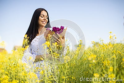 Young woman in the rapeseed field Stock Photo