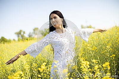 Young woman in the rapeseed field Stock Photo
