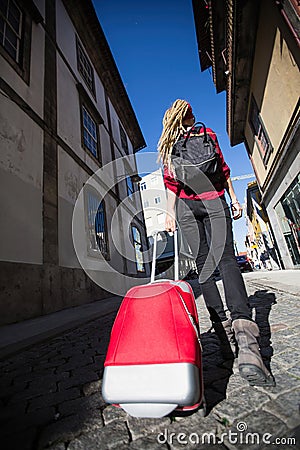 Young woman raveler walking in old european town Stock Photo