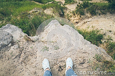 Young woman reaching the top of a mountain. Stock Photo