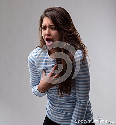 Young woman reacting with loathing and disgust Stock Photo