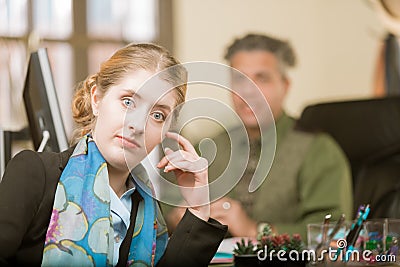 Young Woman Reacting to Clueless Colleague Stock Photo