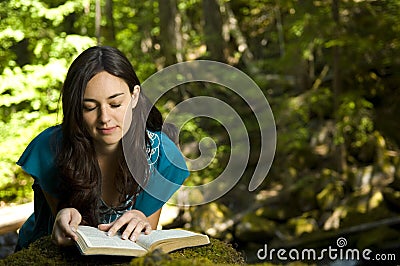 Young woman reading bible Stock Photo