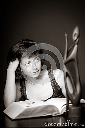 Young woman reading big book, concentration and attentiveness Stock Photo