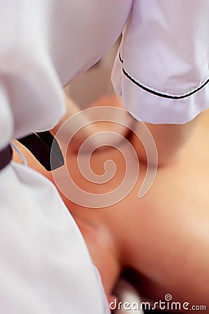 Young woman getting a back massage at the spa. A female patient is being treated by an occupational therapist.Ayurveda Back Stock Photo