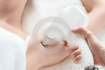 Young woman receiving laser hair removal epilation on armpit Stock Photo