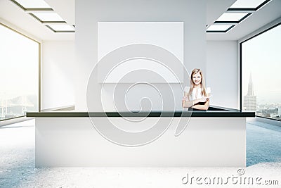 Young woman at reception desk Stock Photo