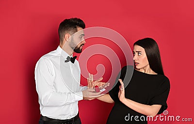 Young woman rejecting engagement ring from boyfriend on background Stock Photo