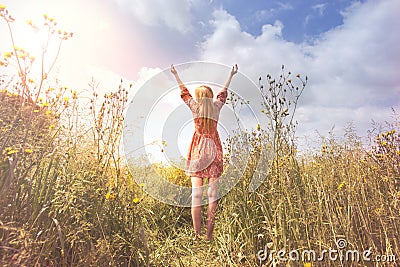 Young woman relaxing with arms raised to the sky in the middle of the nature Stock Photo