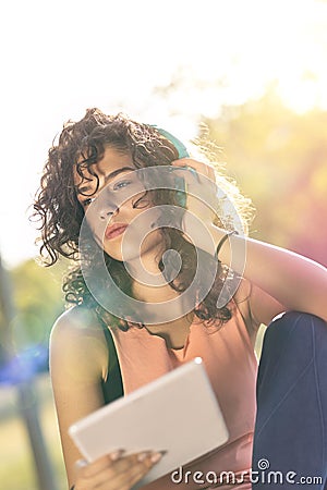 Woman relaxing at the park using a tablet computer Stock Photo