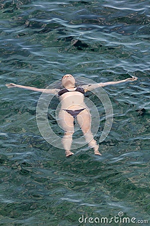 Young woman relaxing on the sea Stock Photo