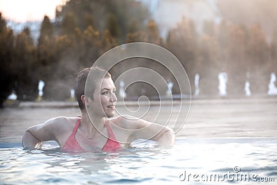 Young woman relaxing in thermal pool. Stock Photo