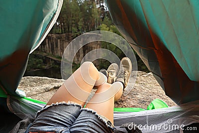 Young woman resting in camping tent, Stock Photo