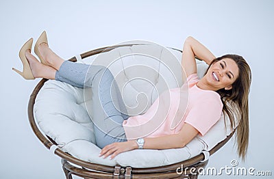 Young woman resting in a comfortable chair. Stock Photo