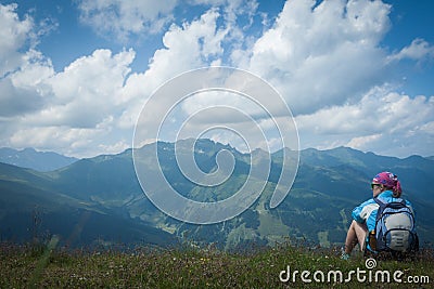 Young woman resting on a mountain hike Stock Photo