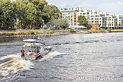 A young woman rides on a water board attached to a boat on the river Editorial Stock Photo