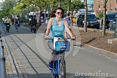 Young woman is riding a Citibike Editorial Stock Photo