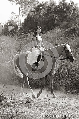 Young woman riding on horse (motion blur) Stock Photo