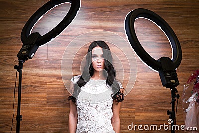 Young woman with ring flash effect. Round LED Circle Lamp Stock Photo