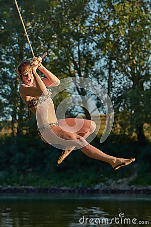 Rope swing river jump Stock Photo