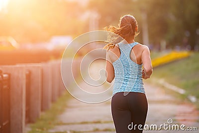 Young woman runner jogging in park in the morning Stock Photo