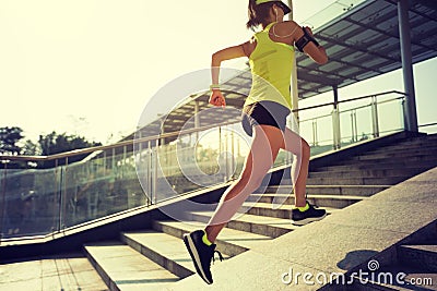 Woman running up city stairs jogging and running Stock Photo