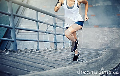 woman runner sportswoman running up city stairs Stock Photo