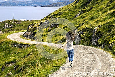 Young woman running along the countryside road Stock Photo