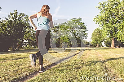 Young woman running, jogging in the park. Exercising outdoor Stock Photo